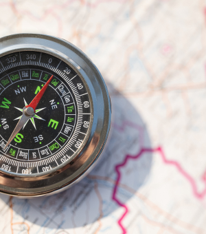 A compass on top of a map